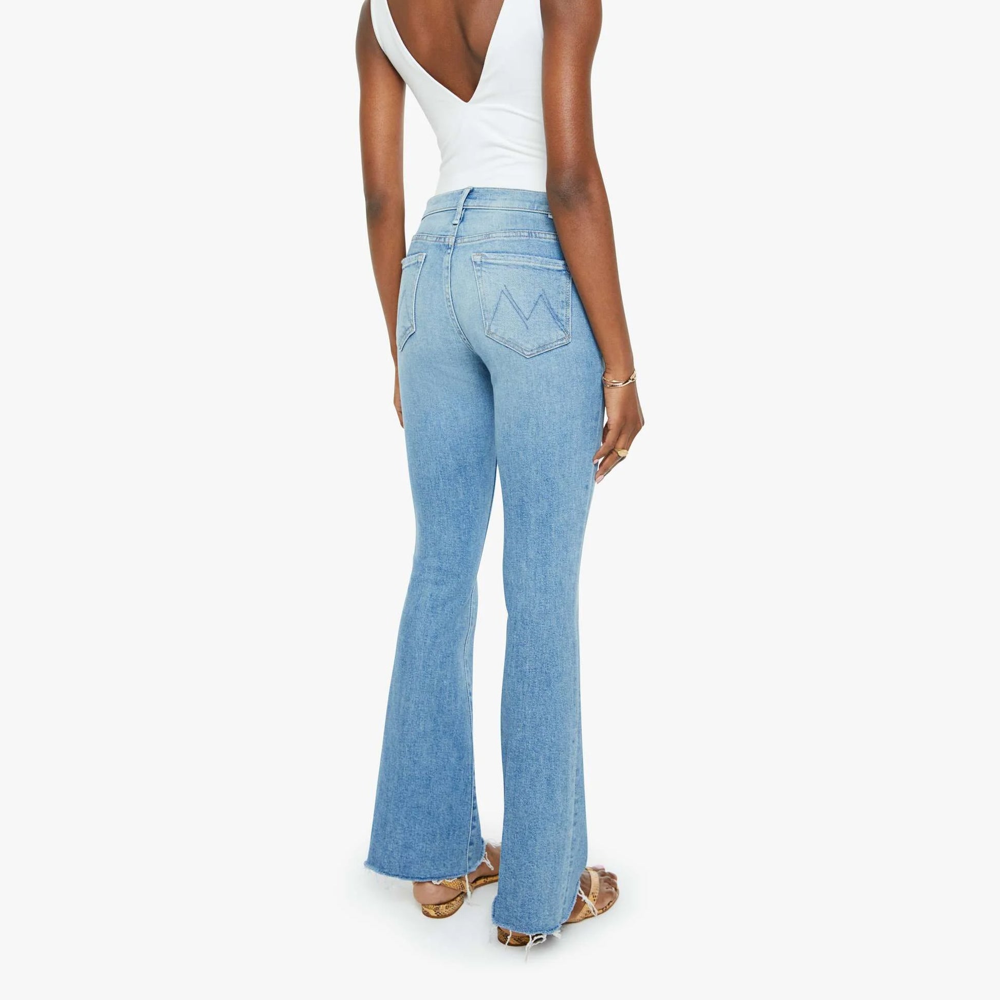 Back view of Weekender Fray jeans in Glow Up, mid-rise flare with frayed hem, showcasing stretch denim.