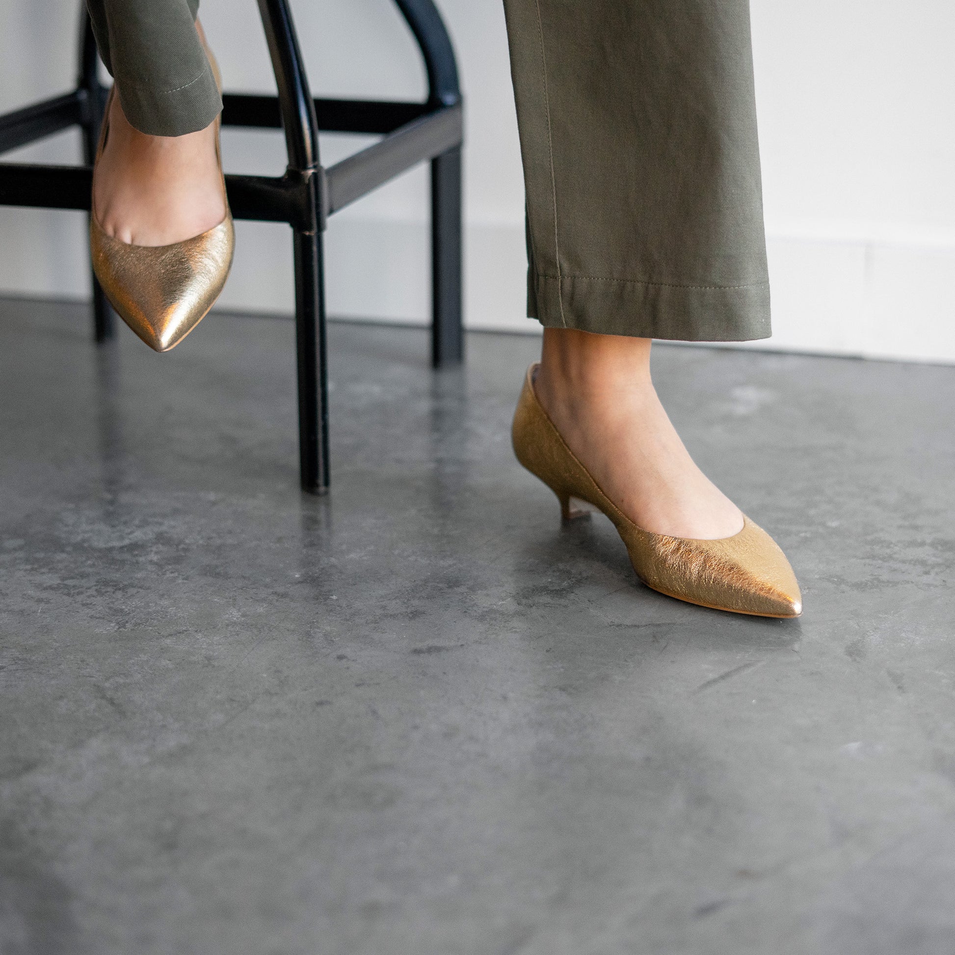 Kitty Point Heel in Warm Gold showcased on a model, featuring a pointed toe and kitten heel design.