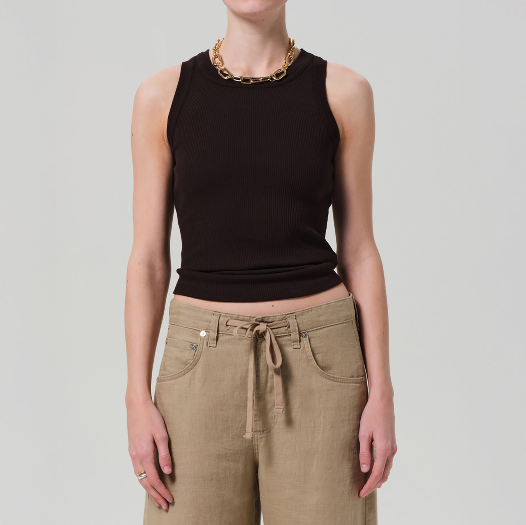Isabel Rib Tank in Chocolate, fitted style, crew neckline, paired with beige trousers, showcasing sustainable fabric blend.