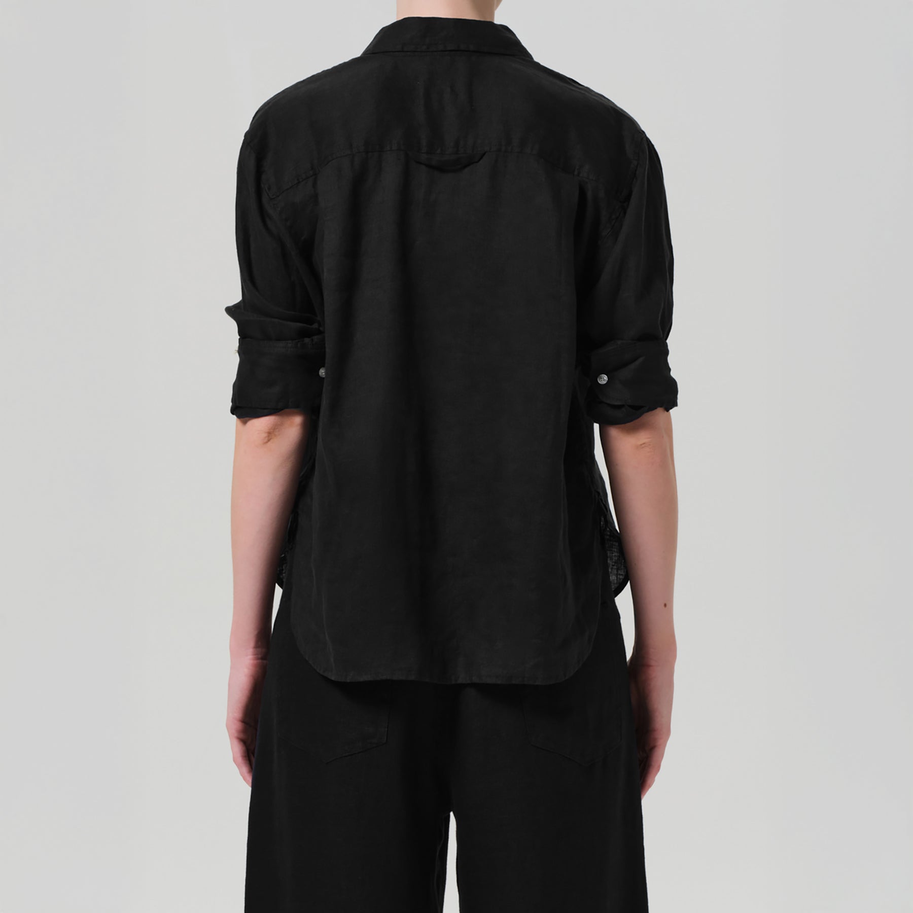 Back view of the Kayla Shrunken Shirt in Black, showcasing its tailored, cropped fit and high-low hem.