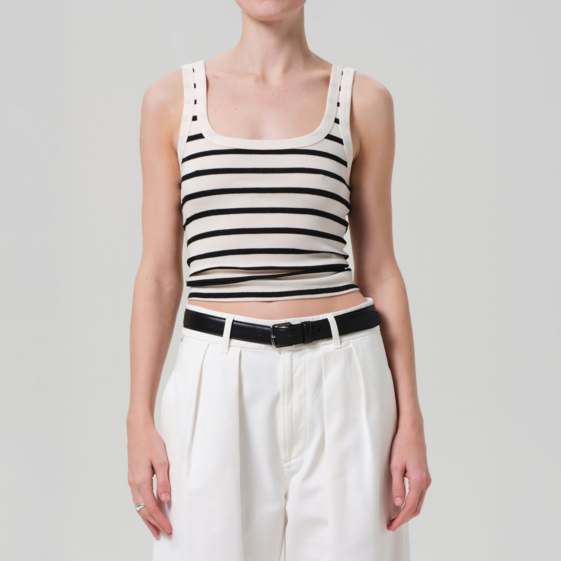 Faye Tank in Midnight Stripe, a slightly cropped tank with U-neckline, shown with stylish white pants.