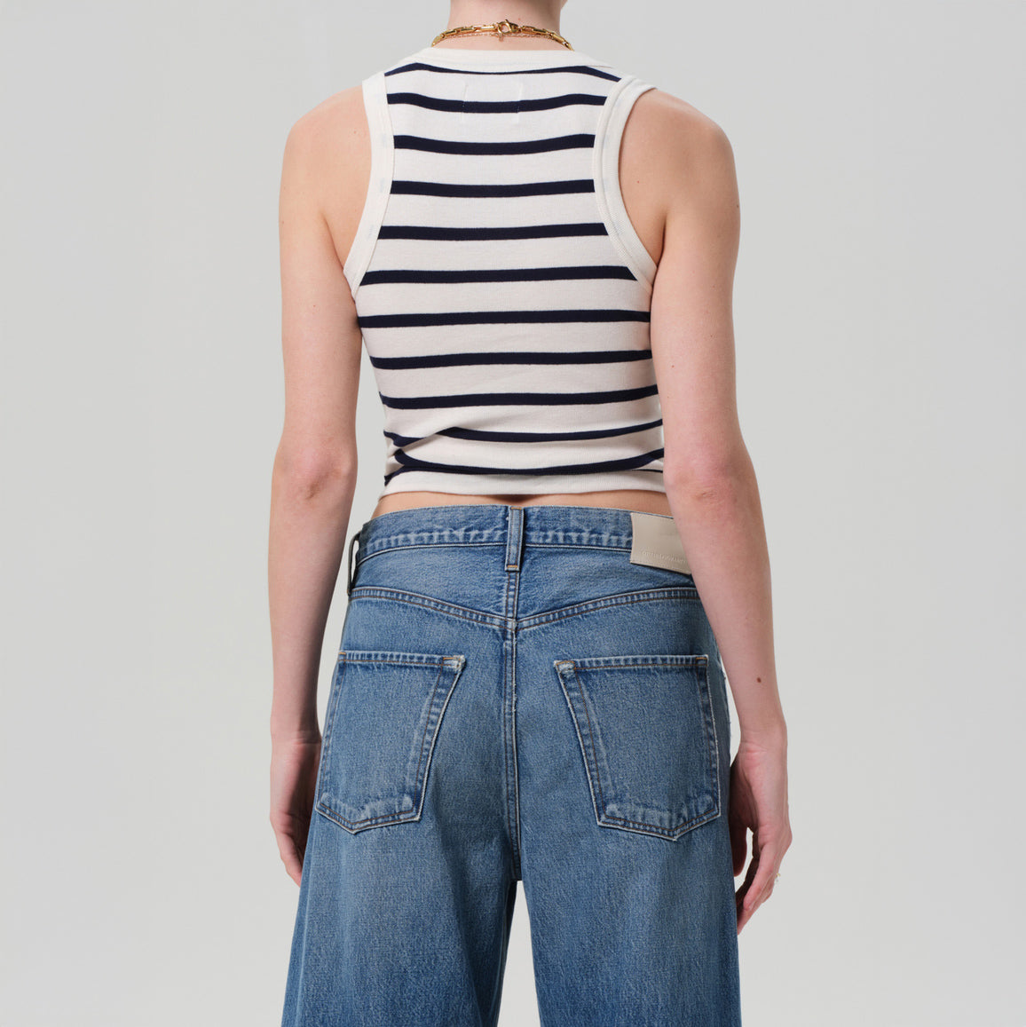 Back view of Caralyn Tank in Azure Stripe, featuring a lightweight ribbed design and paired with high-waisted jeans.