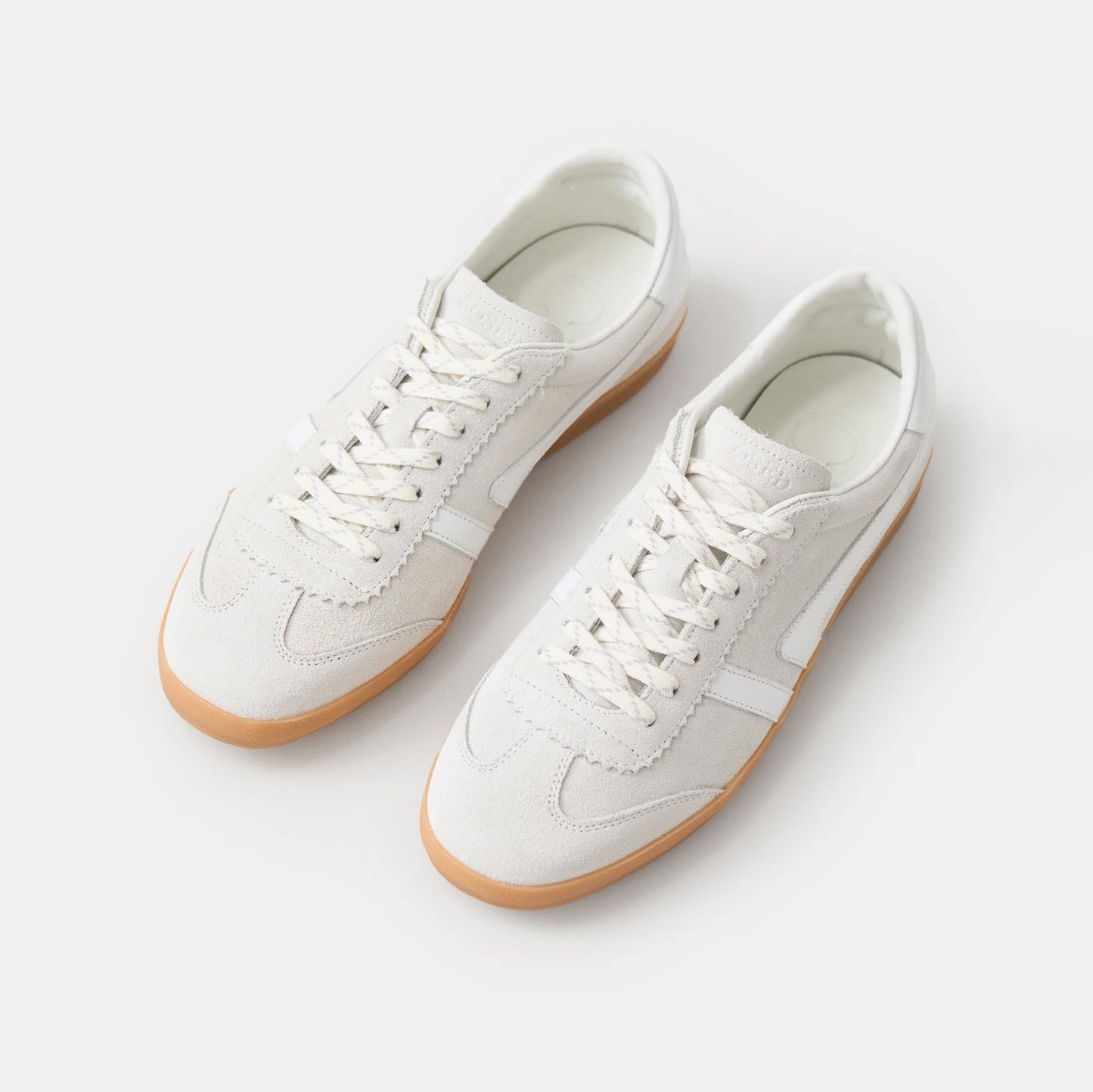Slim white low-top sneakers in Italian nappa leather with suede accents and rubber sole.