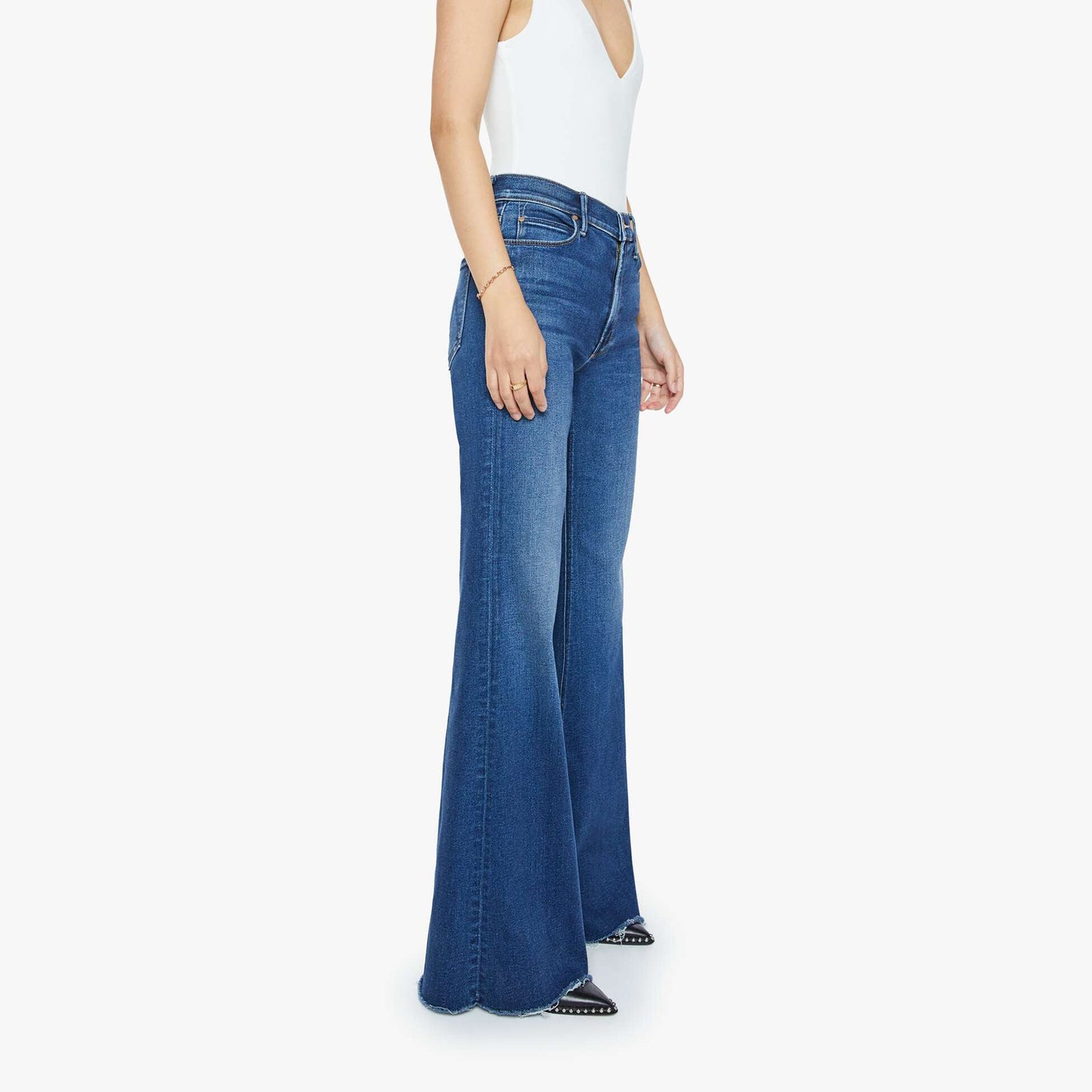 High-rise flare jeans with frayed hem, showcasing a side view on a model in a stylish outfit.