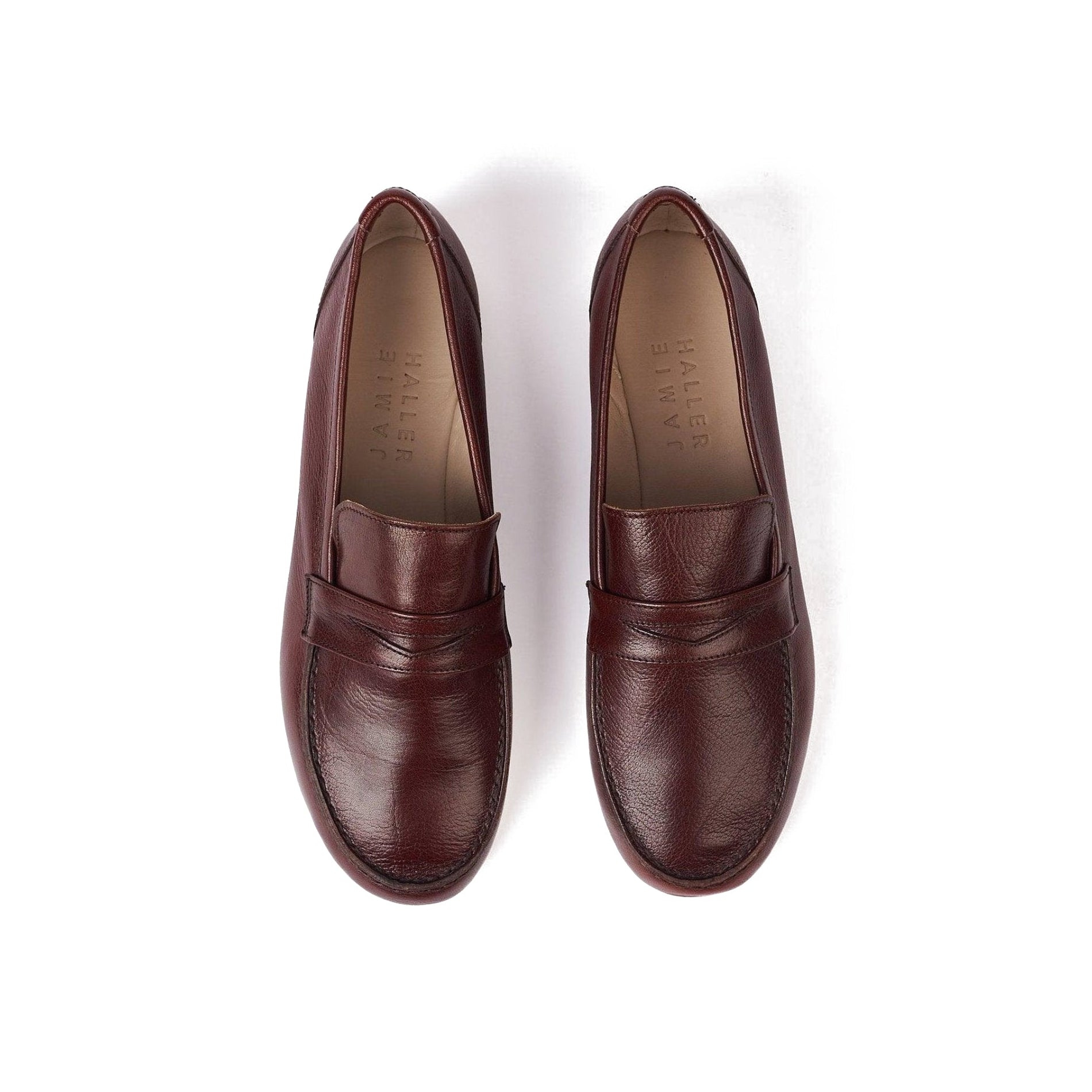 Handcrafted oxblood leather penny loafers with leather lining and sole, offering a glove-like fit.