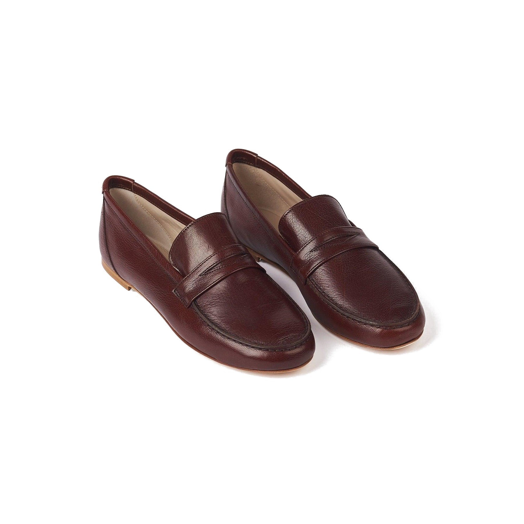 Penny loafer in oxblood leather with hand-waxed exterior and leather lining, handcrafted in Italy.
