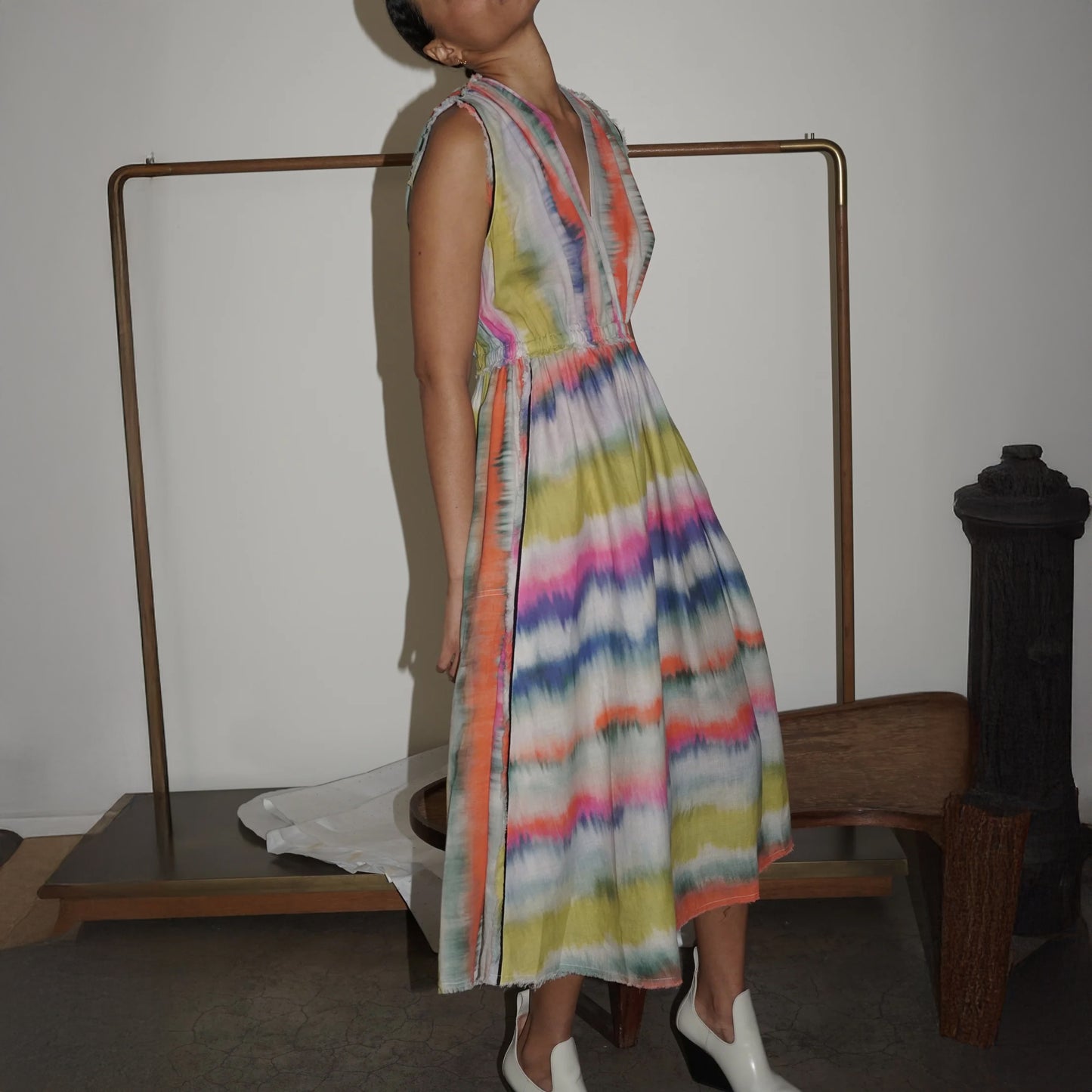 Sleeveless maxi dress in vibrant Ikat stripe with frayed details, featuring full skirt and elasticated waist.