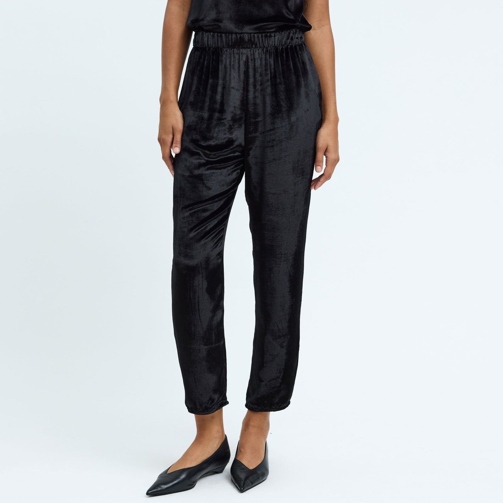Elegant black velvet fez pant with an elastic waistband, side pockets, and a relaxed fit, perfect for stylish casual wear.