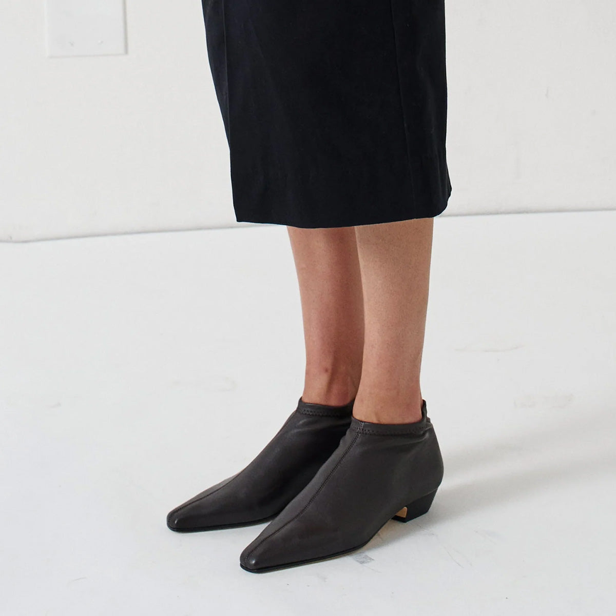 Stretch Low Boot in Black featuring a sleek design and low square stacked heel, made from stretch Italian Lambskin leather.