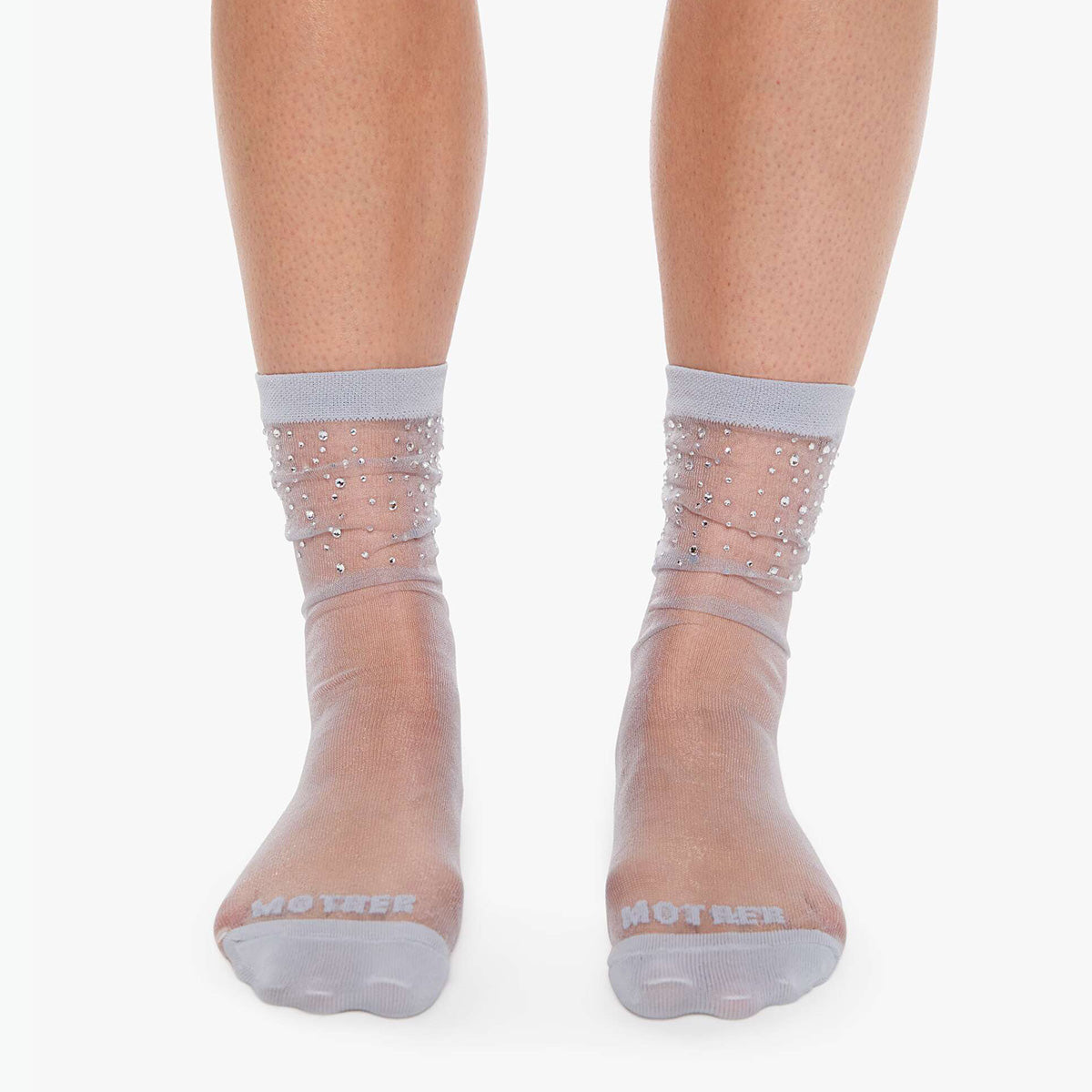 The Half-Step in Sparks sheer tube socks with rhinestones at the ankle, showcasing elegant fashion.