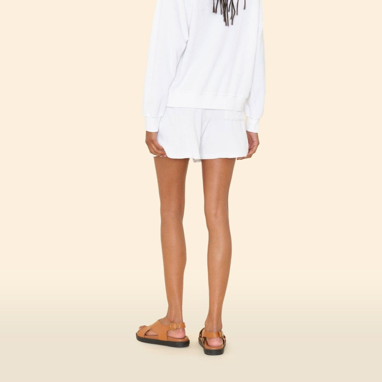 Model wearing Shayden Terry Shorts in White, showcasing a relaxed fit and elastic waistband, paired with a white sweatshirt.
