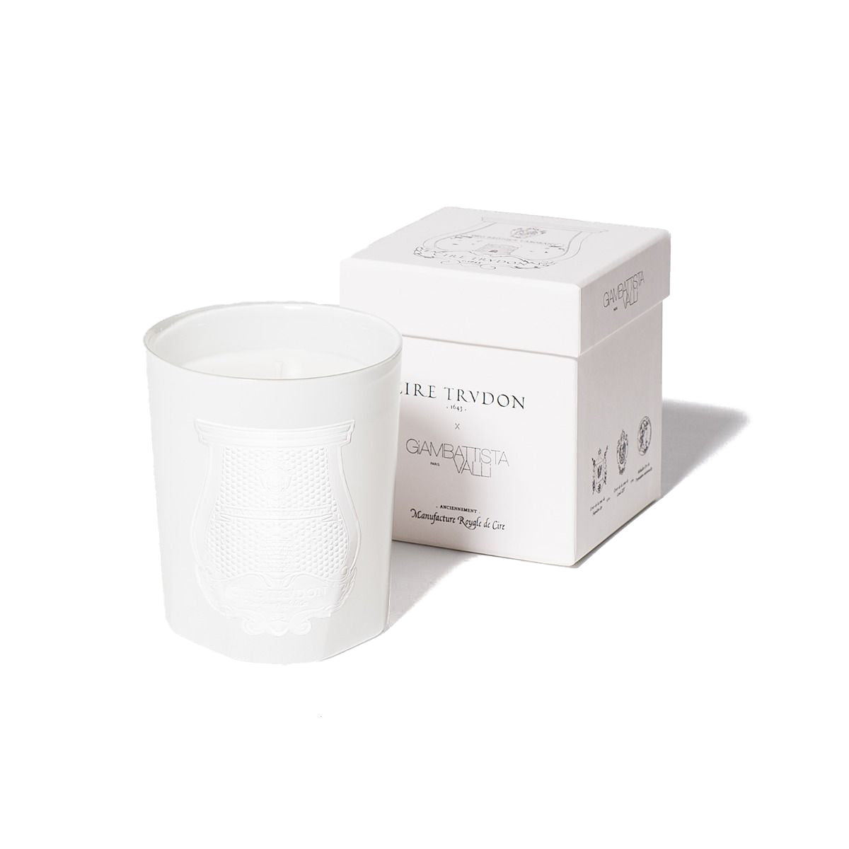 White candle with intricately designed glass and elegant box, representing Positano by Giambattista Valli.