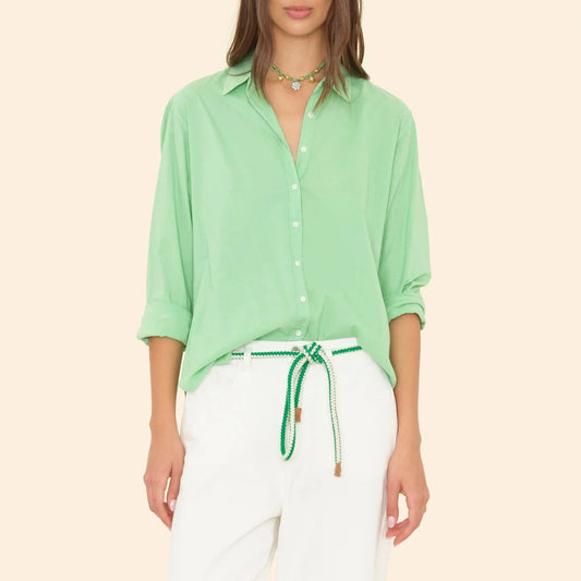 Men's relaxed fit Beau Shirt in pistachio green, featuring front buttons and paired with white pants.