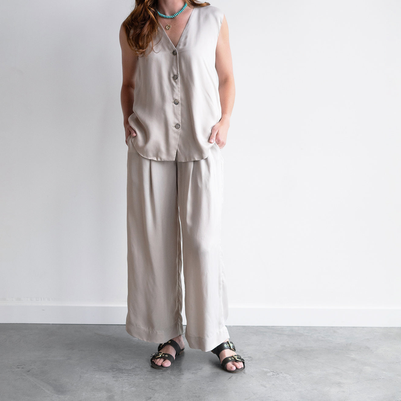 Sanded Trouser in Sisal, featuring an elastic waistband, front pleats, and sustainable fabric, styled with a matching top.
