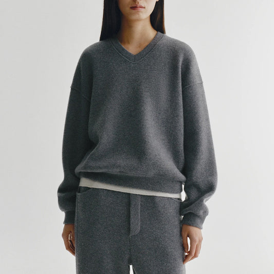 Cyrilla Sweater in Graphite showcased in a relaxed fit with v-neck and dropped shoulders, made of 100% cashmere.
