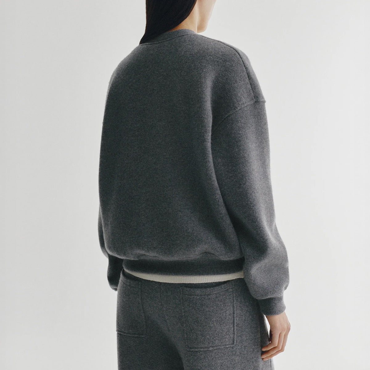 Back view of the relaxed Cyrilla Sweater in Graphite in cashmere with dropped shoulders and full-length sleeves.