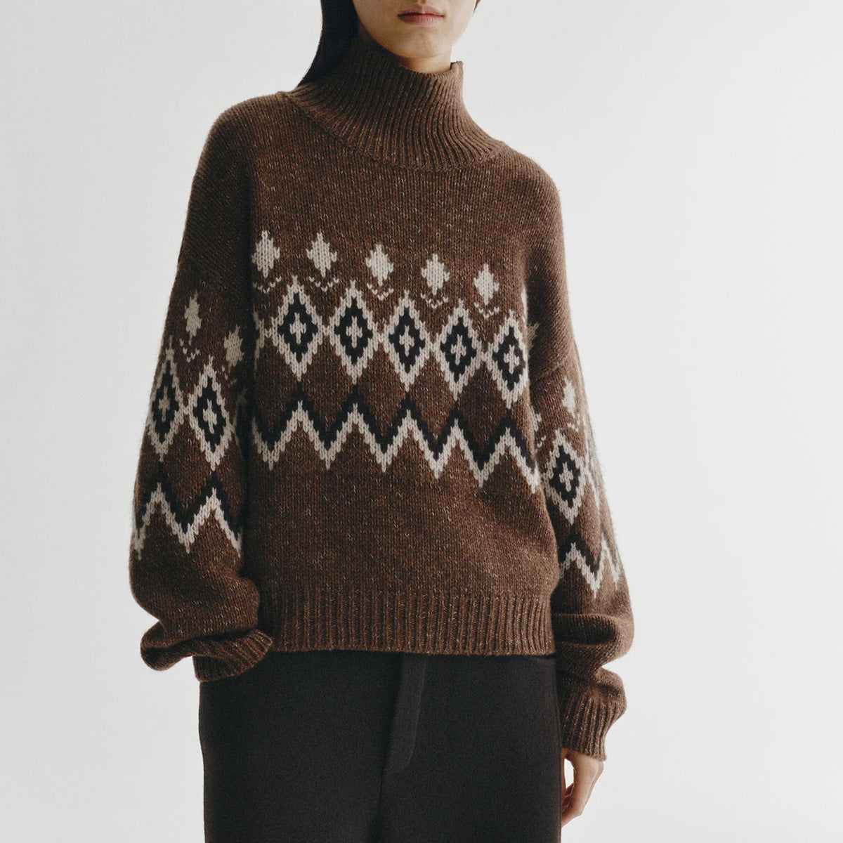 Gudrun in Dark Oak and Sand Fair Isle heavy knit cashmere sweater with high funnel neck and Fair Isle pattern.