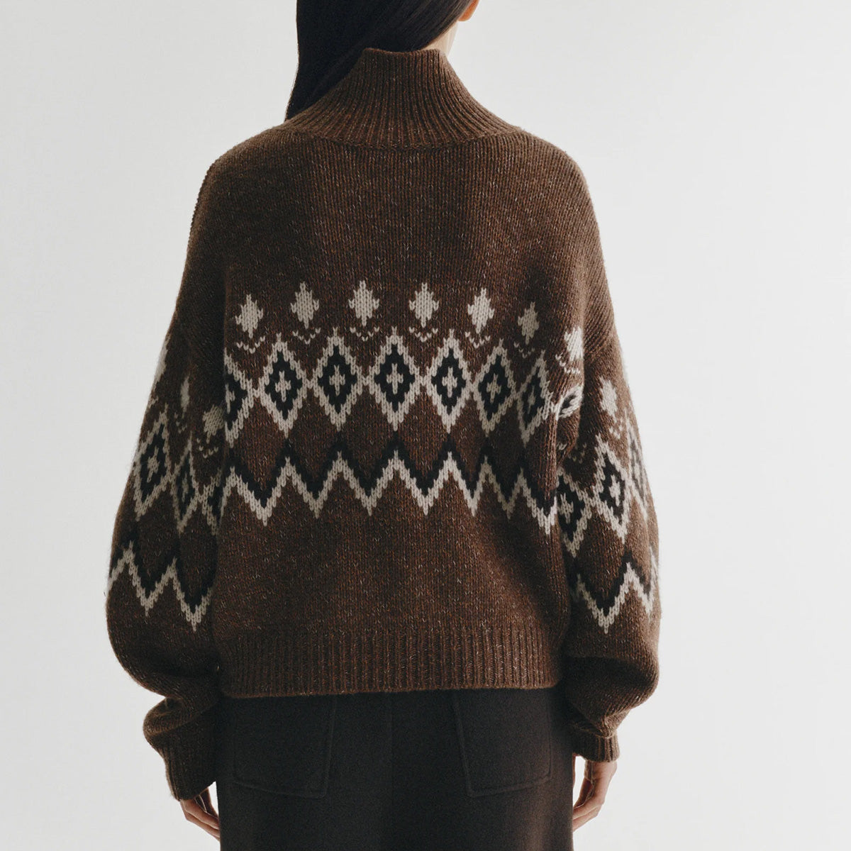 Gudrun in Dark Oak and Sand Fair Isle, showcasing the intricate Fair Isle pattern and high funnel neck design.