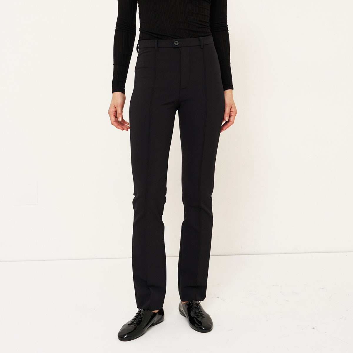 The Riding Pant in Black, slim fit trousers styled like leggings, perfect for versatile dressing.