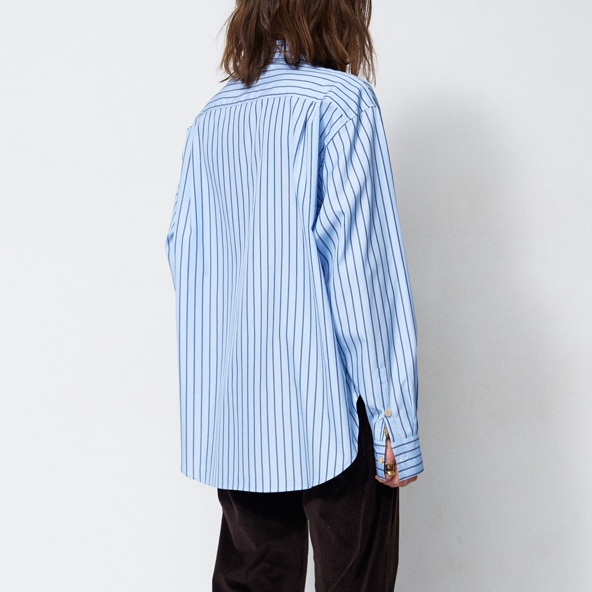 The Asymmetry Shirt in Cornflower Stripe back view featuring blue and white stripes, asymmetric design.