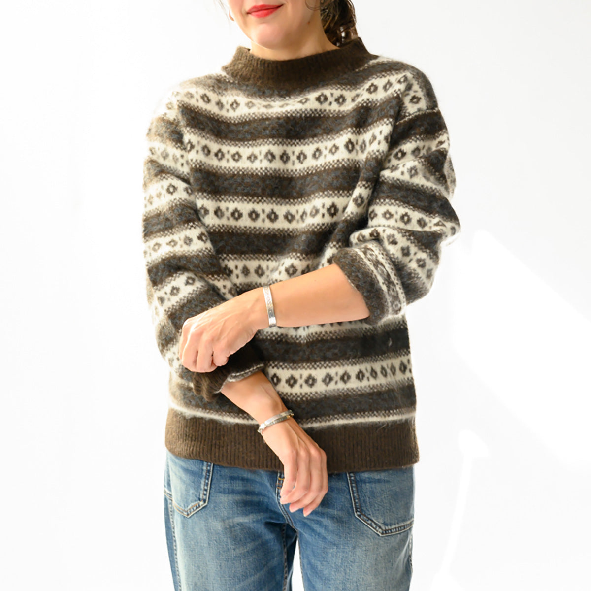 Model wearing Myles Sweater in Sandhamm Jacquard with slouchy design and allover jacquard knit, paired with jeans.