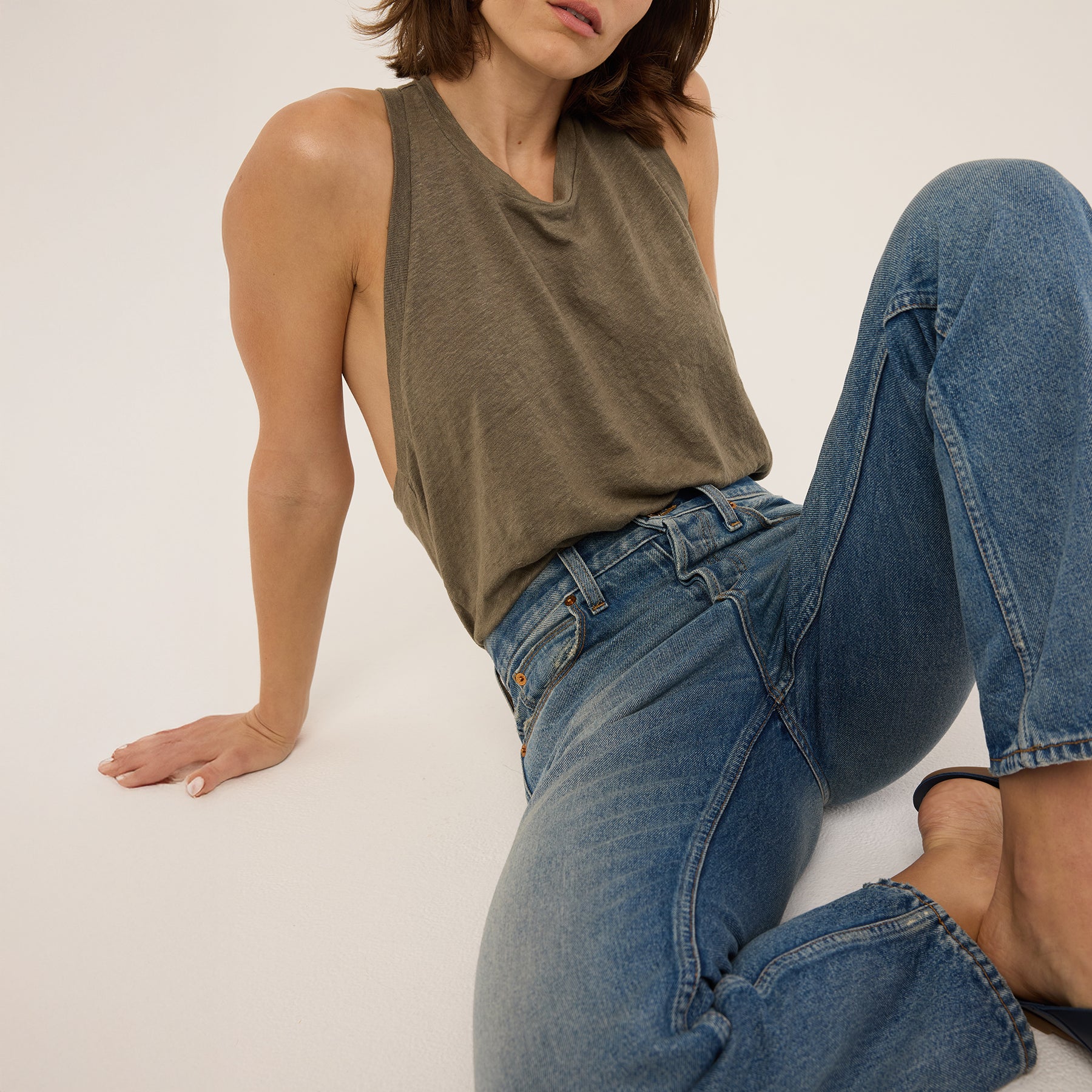 Model wearing Sunday Jean in Borrego Indigo with a high waist and 100% cotton fabric, styled for a casual look.