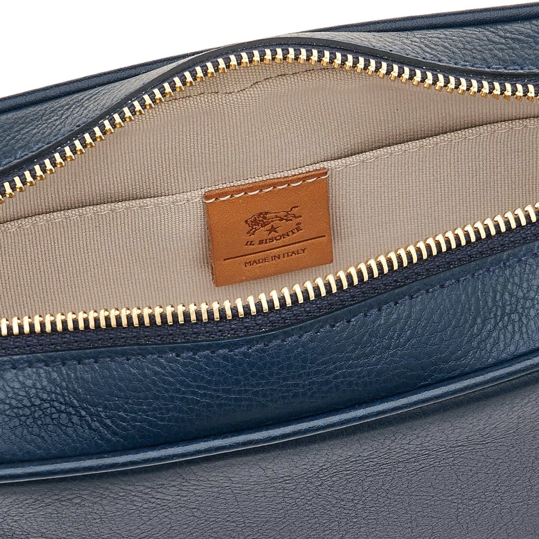 Close-up of the inside of Oliveta Crossbody Bag in blue, featuring zip closure and cotton canvas lining.