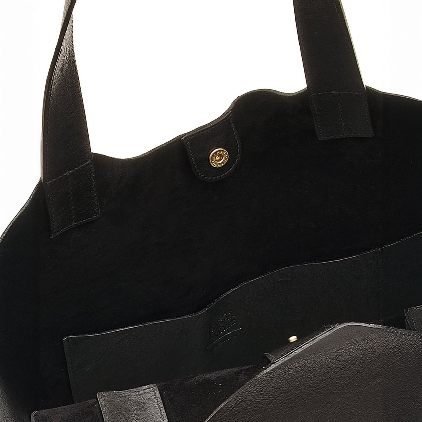 Interior view of Le Laudi black leather tote, featuring suede lining, snap closure, and spacious pocket.