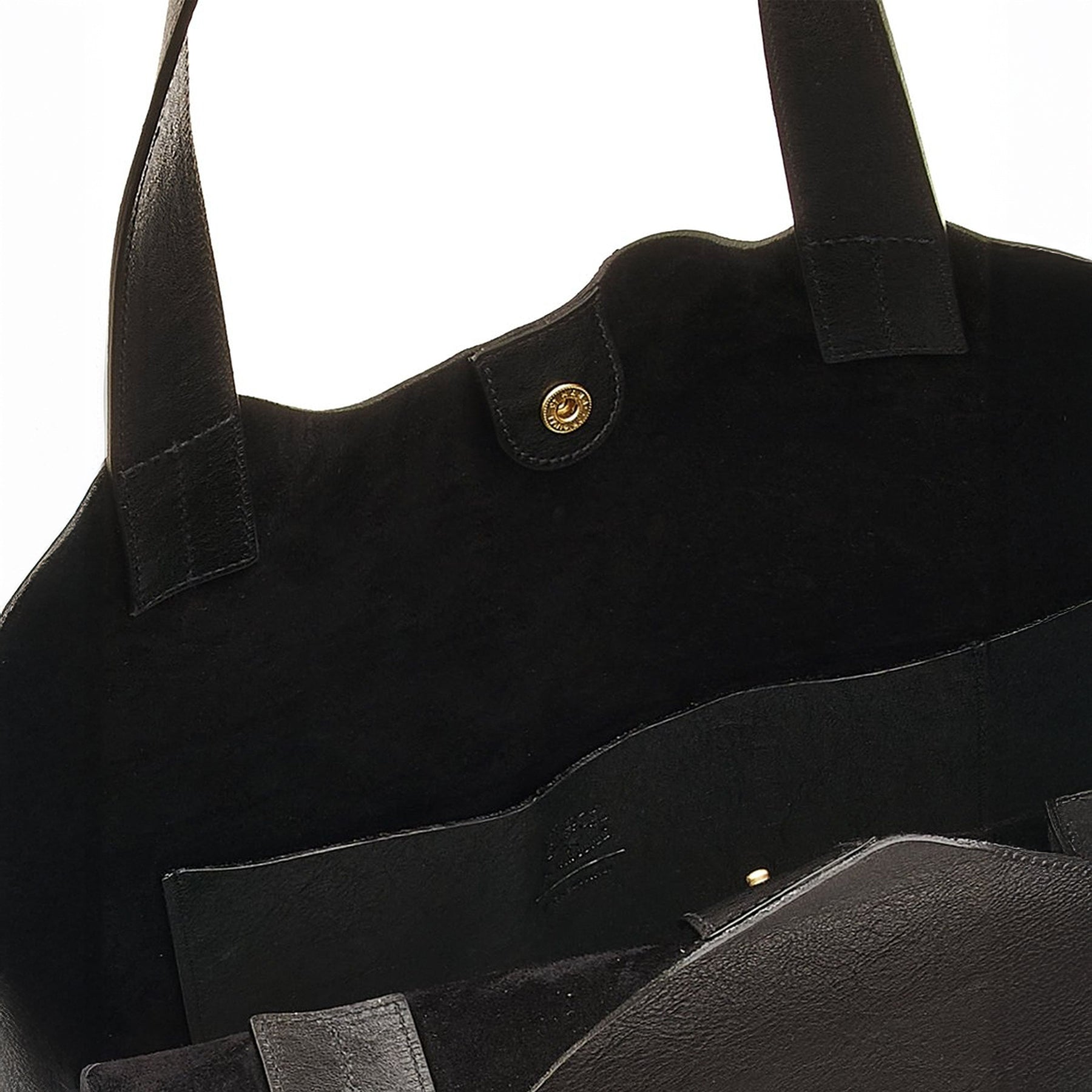 Interior view of Le Laudi black leather tote, featuring suede lining, snap closure, and spacious pocket.