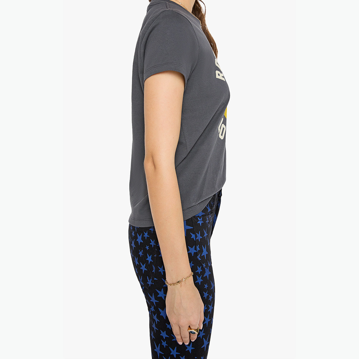 Boxy Goodie Goodie in Rock Is For Cool Girls shown from the side wearing a short-sleeve grey tee with a smiley face graphic.
