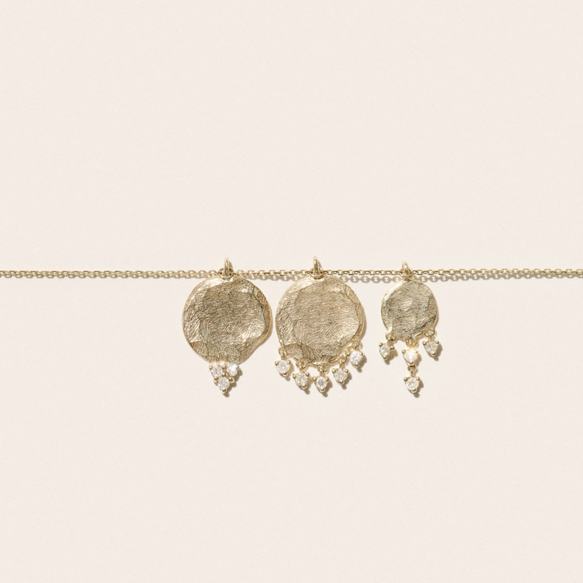 Gaby No.3 Necklace in 9K Yellow Gold featuring textured gold disc pendants with cascading diamonds.