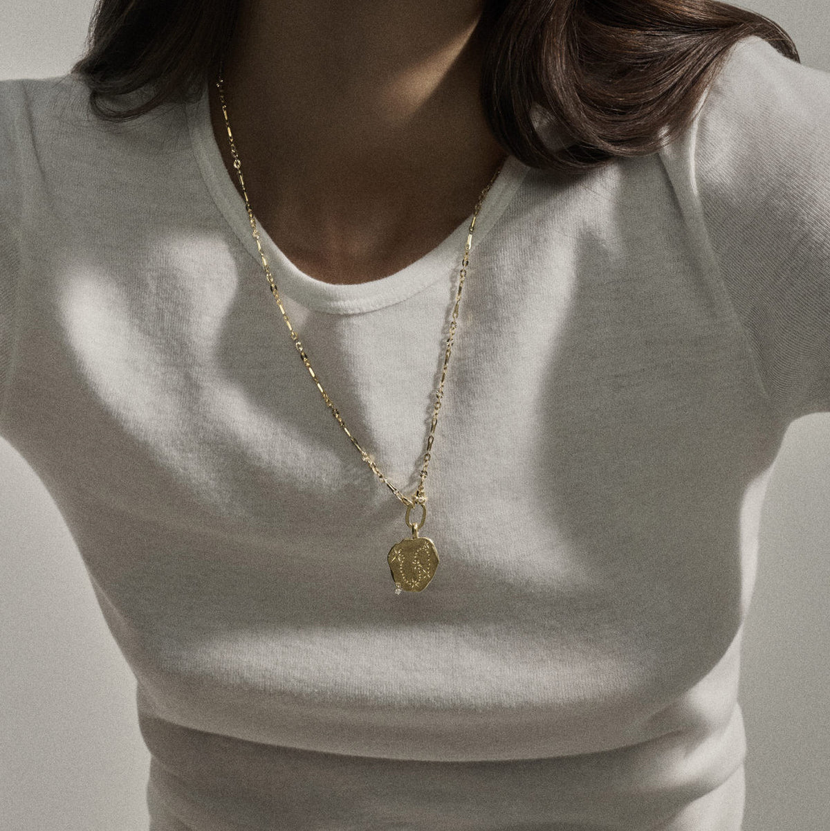 Julieta Necklace in 9K Yellow Gold worn by model, showcasing yellow gold chain and diamond charm.