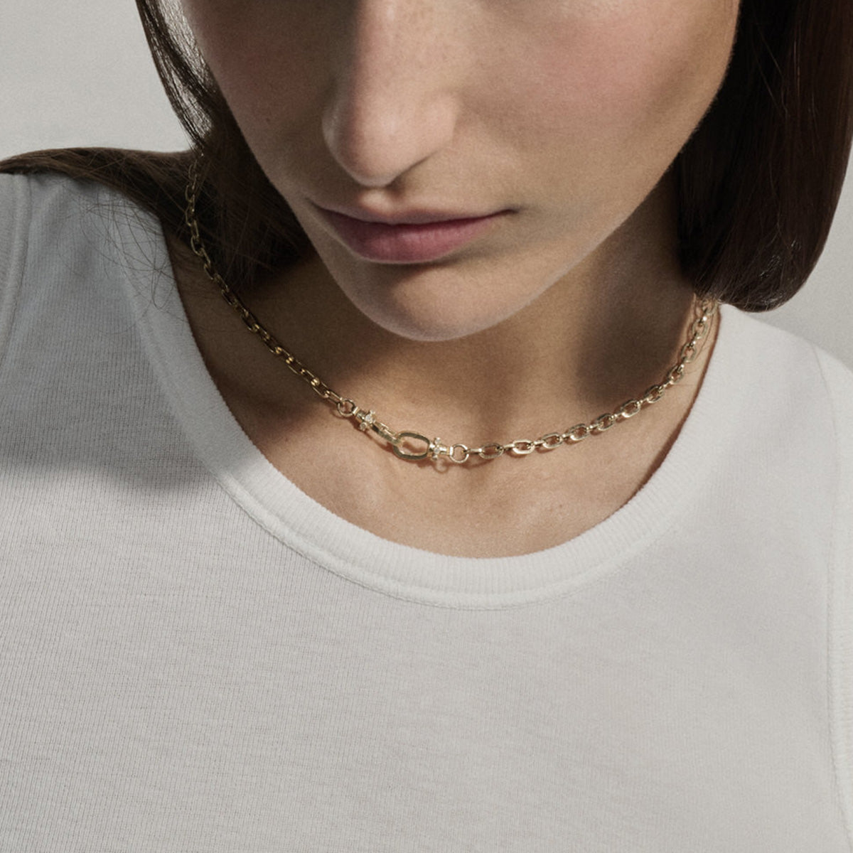 May No. 1 Necklace in 9K Yellow Gold on model, featuring link chain and interlocking lock clasps.
