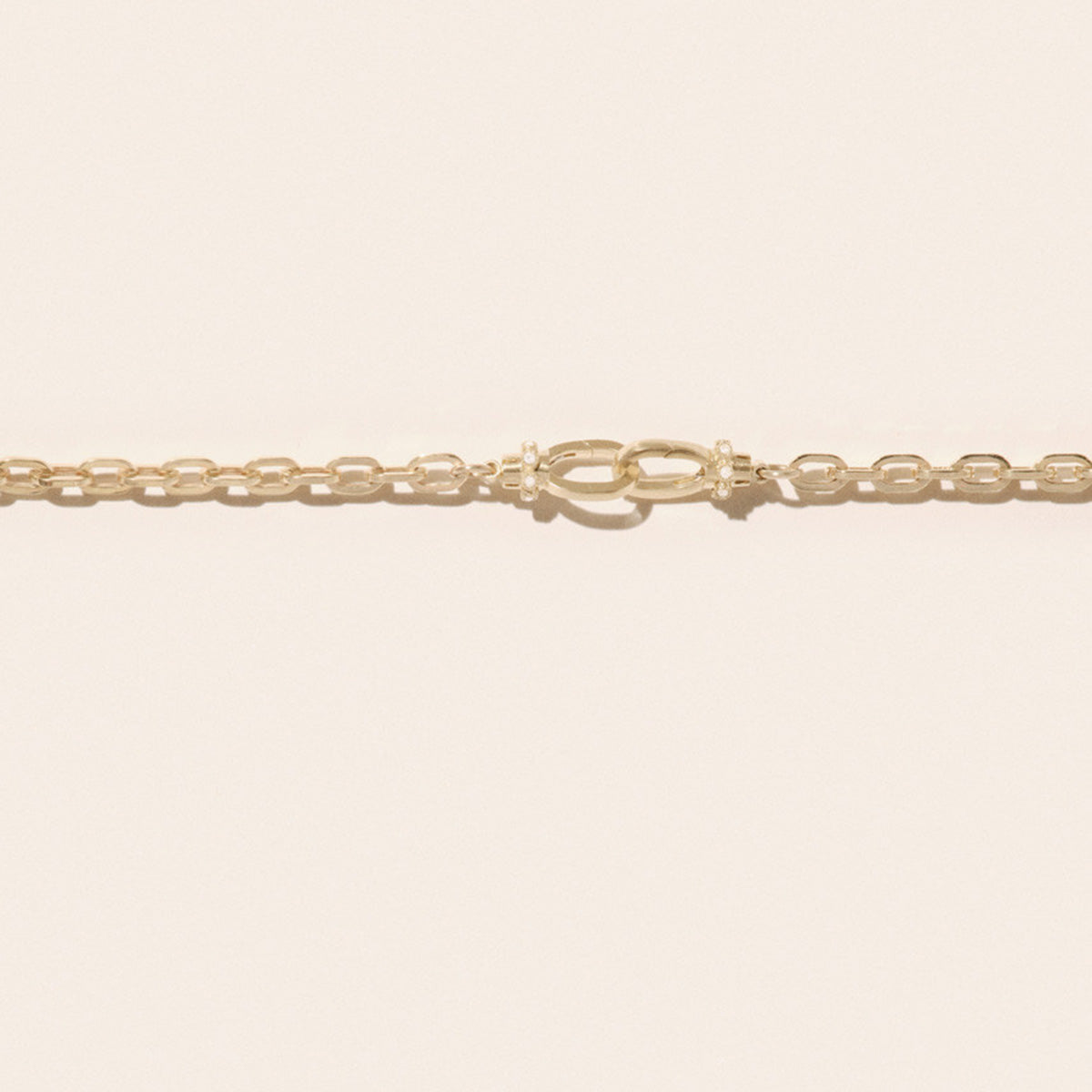 May No. 1 Necklace in 9K Yellow Gold featuring a link chain and interlocking lock clasps.