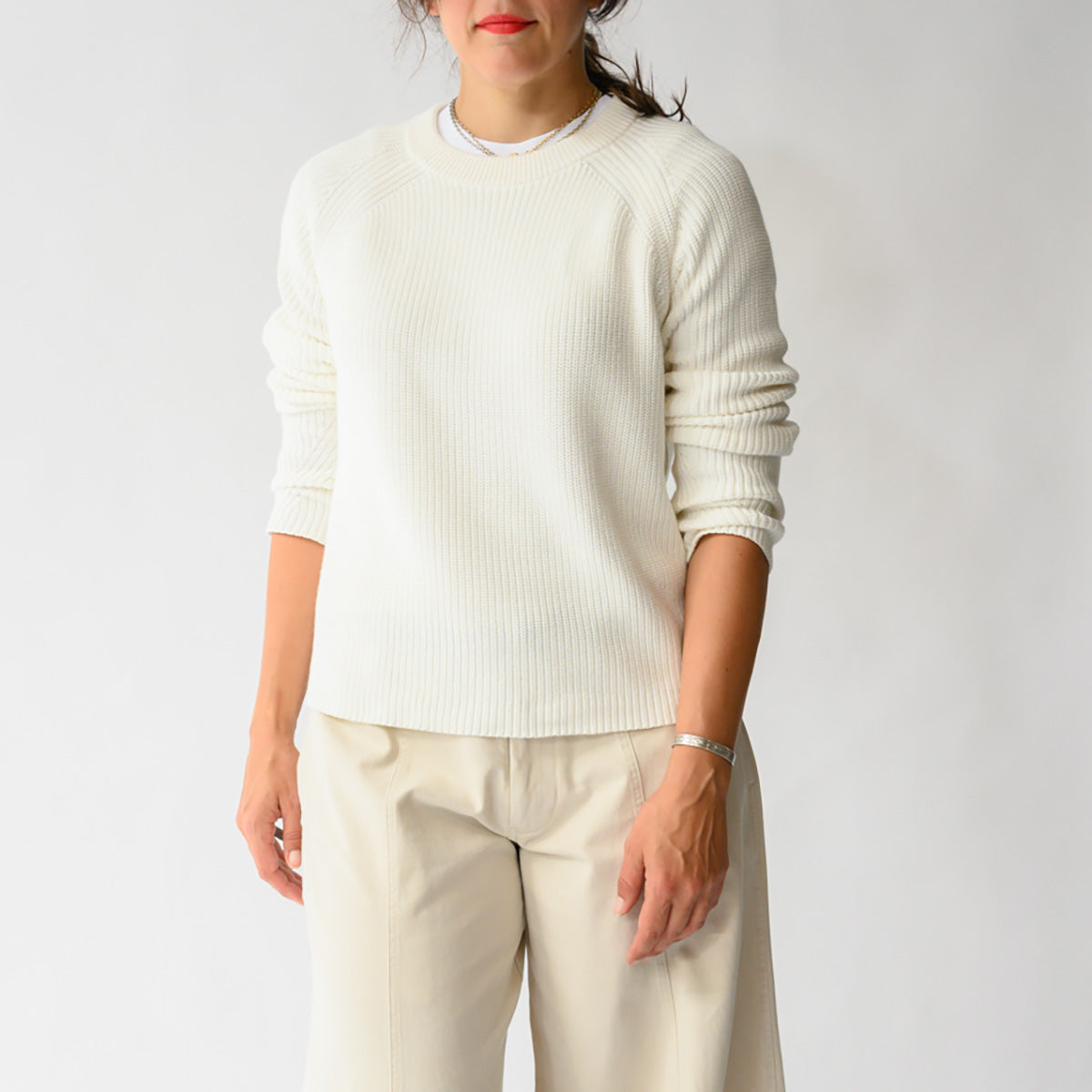 Rib Raglan Crew in Cream worn by a model, showcasing the ribbed texture and raglan sleeves.