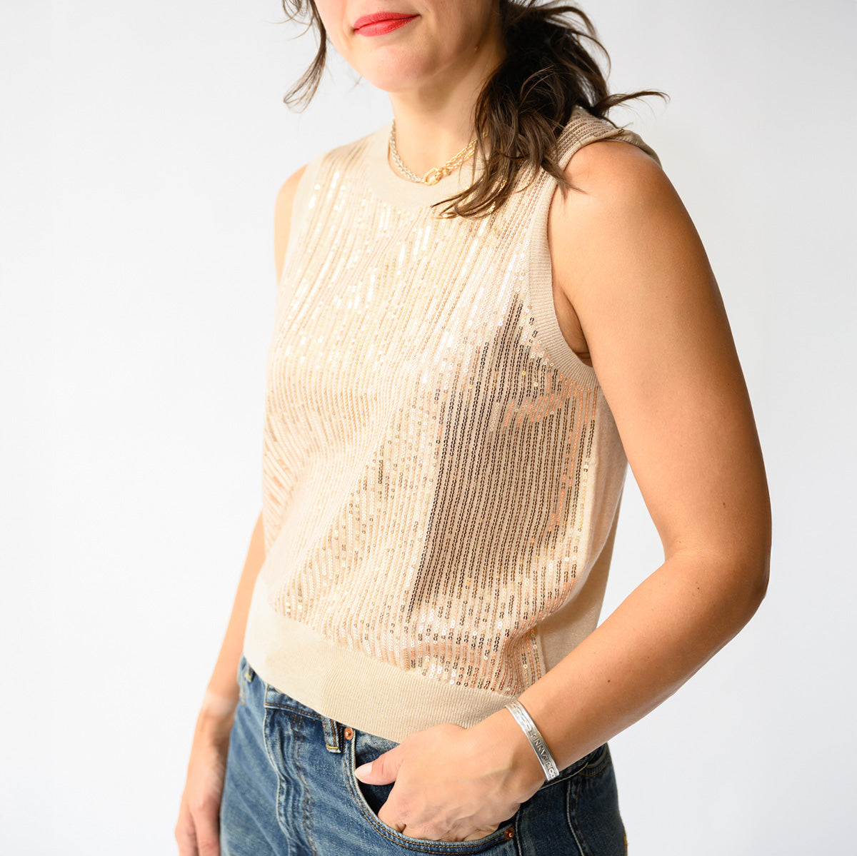 Sequin Party Tank in Sandstone worn by a woman, featuring a sleeveless design and shimmering sequins.