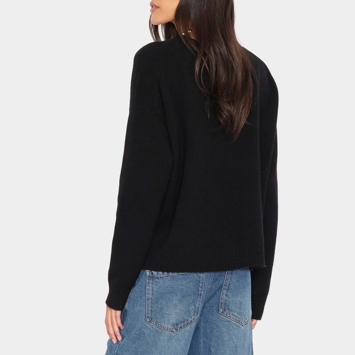 Lela Sweater in Black featuring drop shoulders and ribbed details on the neckline and hem.