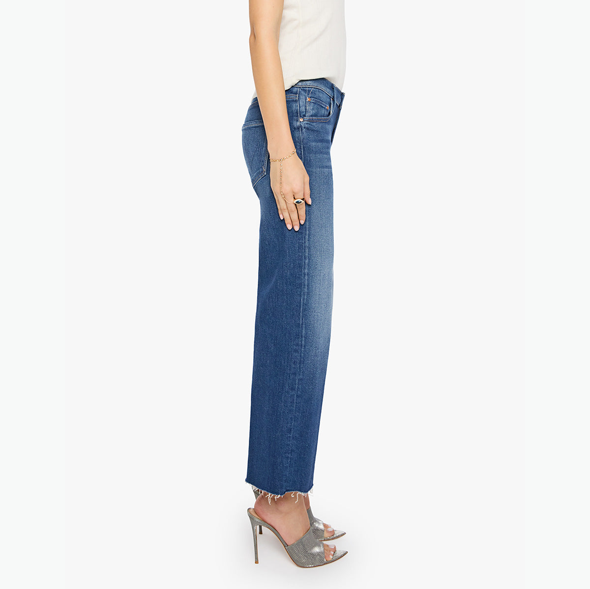 Side view of woman wearing Mid-Rise Rambler in Delux Edition with wide straight legs and raw hem.