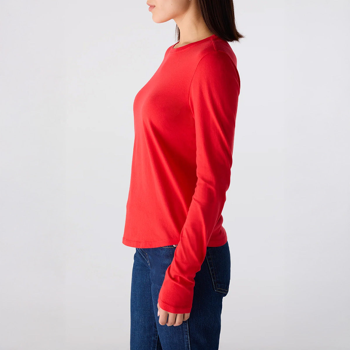 Quinn Longsleeve Tee in Signal, red crew neck tee shown in profile with curved hem and back center seam.
