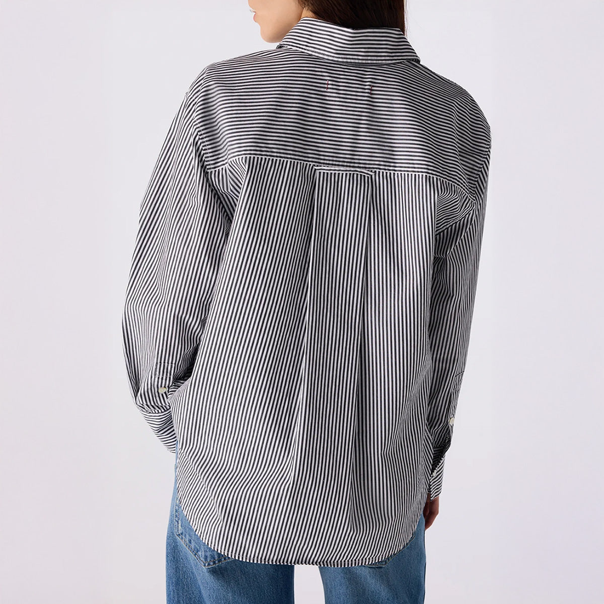 Back view of Ruth Oversized Shirt in Black and Eggshell, featuring a single chest pocket and vertical stripes.