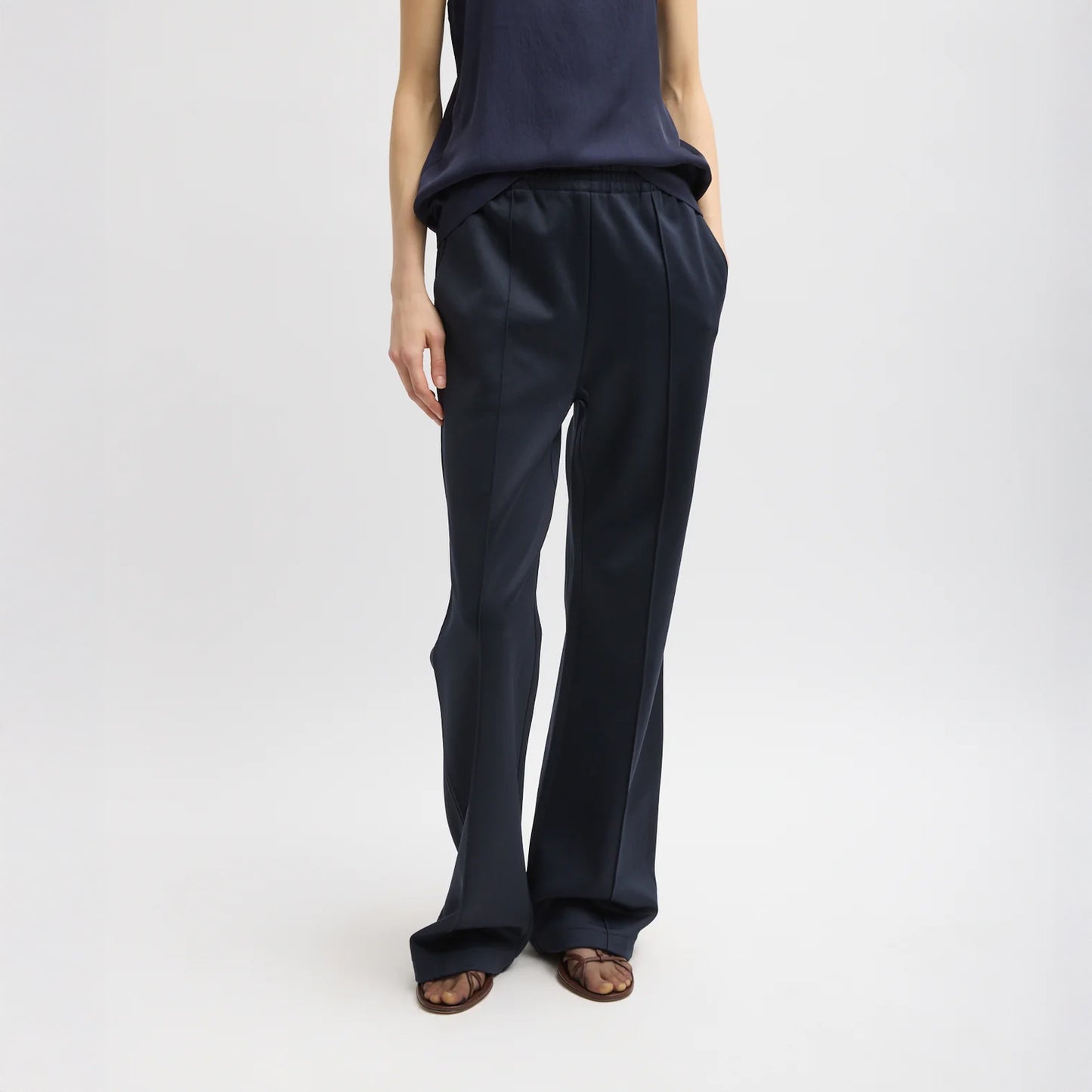 Elastic waist trouser with functional drawstring and oversize back pocket. Snap detail at hem allows for adjustment of pant length. Active knit fabric: 59% polyamide, 38% cotton, 3% elastane Inseam: 33" Front rise: 12.75" Waist: 31" (size S) T000AK3312