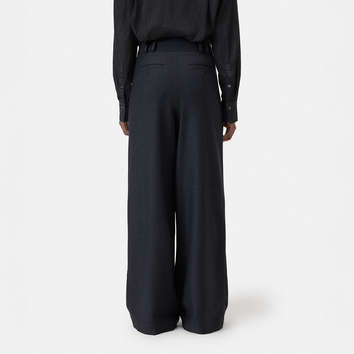 Back view of wide leg high-waist Wes Pant in Black Melange, featuring pleats and a belt detail.